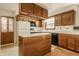 Kitchen featuring wood cabinets, laminate countertops, an island and black appliances at 728 E Main St, Carmel, IN 46032