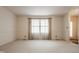 Open living room with a large window, carpet and neutral walls, offering a bright and airy space at 728 E Main St, Carmel, IN 46032