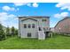 Large backyard showing lawn, deck, exterior of the house and fence line at 769 Canberra Blvd, Westfield, IN 46074