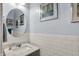 Elegant powder room featuring a marble countertop, subway tile wainscoting, and stylish decor at 769 Canberra Blvd, Westfield, IN 46074