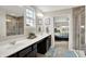 This bathroom features a double sink vanity, large mirror, walk-in shower, and warm neutral colors at 769 Canberra Blvd, Westfield, IN 46074