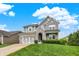 Attractive two-story home with a stone and siding facade, enhanced by a vibrant green lawn and a spacious driveway at 769 Canberra Blvd, Westfield, IN 46074
