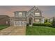 Beautiful two-story home with a stone and siding exterior, complemented by a well-manicured lawn and an attached garage at 769 Canberra Blvd, Westfield, IN 46074