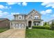 Charming two-story home featuring a stone and gray exterior with a well-manicured lawn at 769 Canberra Blvd, Westfield, IN 46074