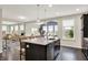 Well-lit kitchen with an island that has bar stool seating, stainless appliances and hardwood floors at 769 Canberra Blvd, Westfield, IN 46074