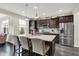 Modern kitchen featuring dark cabinets, stainless steel appliances, and a granite island at 769 Canberra Blvd, Westfield, IN 46074