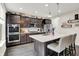Gourmet kitchen with a large island, stainless steel appliances, and elegant dark cabinetry at 769 Canberra Blvd, Westfield, IN 46074
