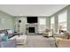 Inviting living room with a stone fireplace, comfortable seating, and plenty of natural light at 769 Canberra Blvd, Westfield, IN 46074