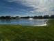 Picturesque pond with a fountain, set against a backdrop of well-kept lawns and charming residential homes at 769 Canberra Blvd, Westfield, IN 46074