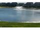 Scenic view of a pond with a fountain feature, surrounded by well-maintained lawns and residential houses at 769 Canberra Blvd, Westfield, IN 46074
