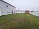 Expansive backyard with a storage shed, privacy fence, and a patio with seating near the house at 7814 Crooked Meadows Dr, Indianapolis, IN 46268
