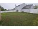 Extensive backyard with a red storage shed, a white privacy fence, and a well-maintained lawn at 7814 Crooked Meadows Dr, Indianapolis, IN 46268