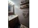 Stylish bathroom features a wood vanity, decorative shelving, trendy decor, and ample counter space at 7814 Crooked Meadows Dr, Indianapolis, IN 46268
