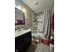 Cozy bathroom features a tiled shower with a safety grab bar, a dark wood vanity, and new fixtures at 7814 Crooked Meadows Dr, Indianapolis, IN 46268