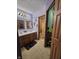 Bathroom featuring a double vanity, mirrors, and ample storage, with a glimpse into the toilet and shower area at 7814 Crooked Meadows Dr, Indianapolis, IN 46268