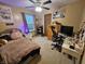 Neutral toned bedroom features a comfortable bed, ceiling fan, and decorative artwork and shelving at 7814 Crooked Meadows Dr, Indianapolis, IN 46268