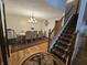 Elegant dining room featuring wood floors, a large table with seating for six and decorative lighting at 7814 Crooked Meadows Dr, Indianapolis, IN 46268