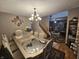 Elegant dining room showcasing wood floors, a large table with seating for six, decorative lighting and a staircase view at 7814 Crooked Meadows Dr, Indianapolis, IN 46268