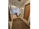 Upstairs hallway with neutral carpet leads to the bedrooms and features a wooden banister overlooking the stairs at 7814 Crooked Meadows Dr, Indianapolis, IN 46268