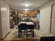 Well-lit kitchen with wooden cabinetry, stainless steel appliances, and a cozy dining area with seating at 7814 Crooked Meadows Dr, Indianapolis, IN 46268