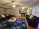Open-concept living room showcases hardwood floors, modern furnishings and a view into the adjacent kitchen at 7814 Crooked Meadows Dr, Indianapolis, IN 46268