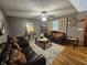 Inviting living room featuring plush seating, decorative curtains, a ceiling fan, wood-look floors and decorative accents at 7814 Crooked Meadows Dr, Indianapolis, IN 46268
