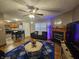 Inviting living room featuring a fireplace, modern decor, ceiling fan and a glimpse of the kitchen at 7814 Crooked Meadows Dr, Indianapolis, IN 46268