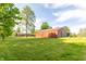 View of barn on a large grassy lot with home in the background at 8292 E 100 S, Greenfield, IN 46140