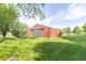View of a barn on a large grassy lot under a bright blue sky at 8292 E 100 S, Greenfield, IN 46140