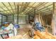 Barn interior featuring lawn equipment including a zero-turn mower and wheelbarrow at 8292 E 100 S, Greenfield, IN 46140