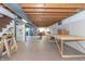 Unfinished basement features exposed ductwork, concrete walls and floor, and shelving for storage or projects at 8292 E 100 S, Greenfield, IN 46140