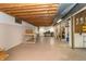 Spacious unfinished basement area with exposed wooden beams and concrete floor for potential customization at 8292 E 100 S, Greenfield, IN 46140