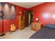 Red bedroom displays a brick accent wall, guitar, and wood furnishings offering a unique, inviting look at 8292 E 100 S, Greenfield, IN 46140