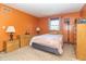 Bedroom features warm-colored walls, one large window, side tables and lamps at 8292 E 100 S, Greenfield, IN 46140