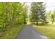 Long, paved driveway leading through lush greenery and trees, providing a scenic entrance to the property at 8292 E 100 S, Greenfield, IN 46140