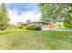 A sprawling lawn surrounds this house with a long driveway leading to an attached two-car garage at 8292 E 100 S, Greenfield, IN 46140