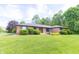 Well-manicured front lawn and landscaping highlight this charming brick home at 8292 E 100 S, Greenfield, IN 46140