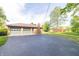 A paved driveway leads to a spacious two-car attached garage at 8292 E 100 S, Greenfield, IN 46140