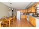 Bright kitchen with wood cabinets, a dining table, and modern appliances at 8292 E 100 S, Greenfield, IN 46140