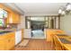 Eat-in kitchen features wood cabinets, brick backsplash, updated appliances, and seamless access to the living area at 8292 E 100 S, Greenfield, IN 46140