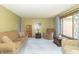 Comfortable living room with neutral tones, a large window, and plush furniture at 8292 E 100 S, Greenfield, IN 46140
