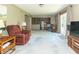 Spacious living room flows to the kitchen, featuring a recliner, and an adjacent eating area at 8292 E 100 S, Greenfield, IN 46140