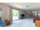 Bright living room boasts a brick fireplace, sliding glass doors, and ample seating with plush carpeting at 8292 E 100 S, Greenfield, IN 46140