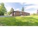 Exterior rear view of the home showcasing the brick facade and a small deck at 8292 E 100 S, Greenfield, IN 46140