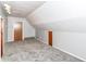 Attic featuring unique lighting fixtures, carpet, and neutral walls, creating a versatile additional space at 8308 W Main St, Coatesville, IN 46121