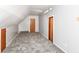 Attic featuring unique lighting, carpet, and neutral walls, creating a versatile and functional additional space at 8308 W Main St, Coatesville, IN 46121