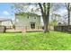Expansive backyard with a well-maintained lawn, mature trees, and a charming wooden deck for outdoor enjoyment at 8308 W Main St, Coatesville, IN 46121