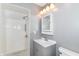Bathroom featuring a tiled walk-in shower, sleek vanity with storage, modern fixtures, and neutral color scheme at 8308 W Main St, Coatesville, IN 46121
