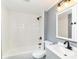 Updated bathroom featuring a shower and tub combo, toilet, and gray vanity at 8308 W Main St, Coatesville, IN 46121
