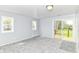 Bedroom featuring new carpet, natural light, and access to the backyard deck at 8308 W Main St, Coatesville, IN 46121